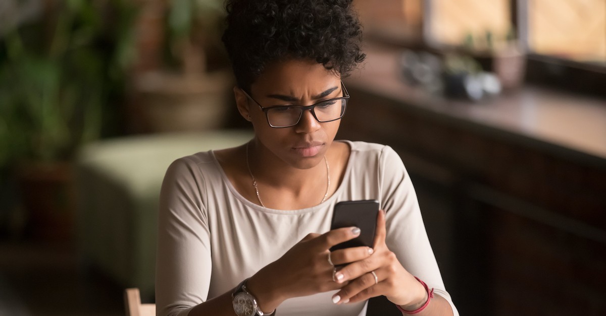 frustrated woman looking at phone, is anger a sin?