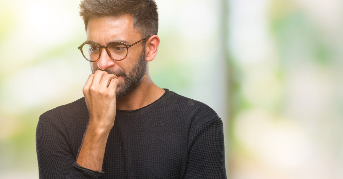 man biting nails scared worried fear of death