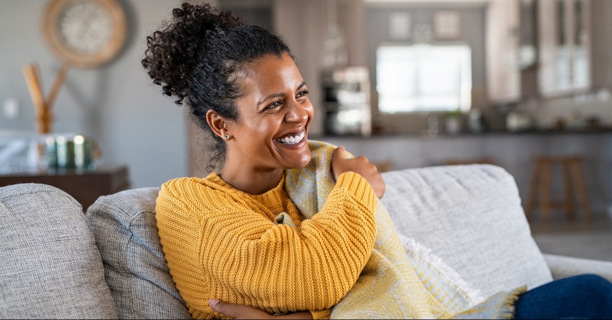 Woman smiling on her couch