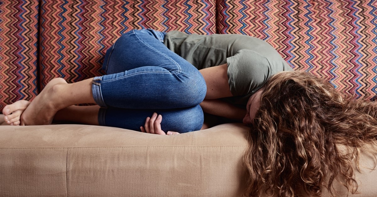 woman crying on couch, mystery of evil