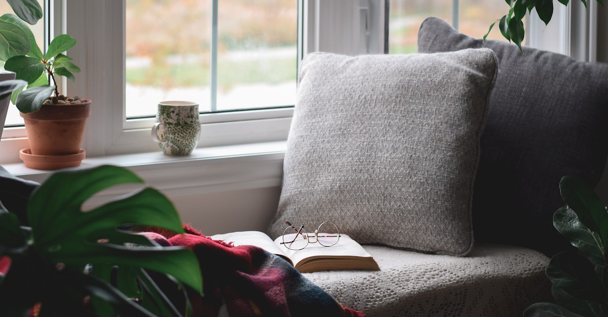 Cozy fall reading nook glasses book and coffee mug window