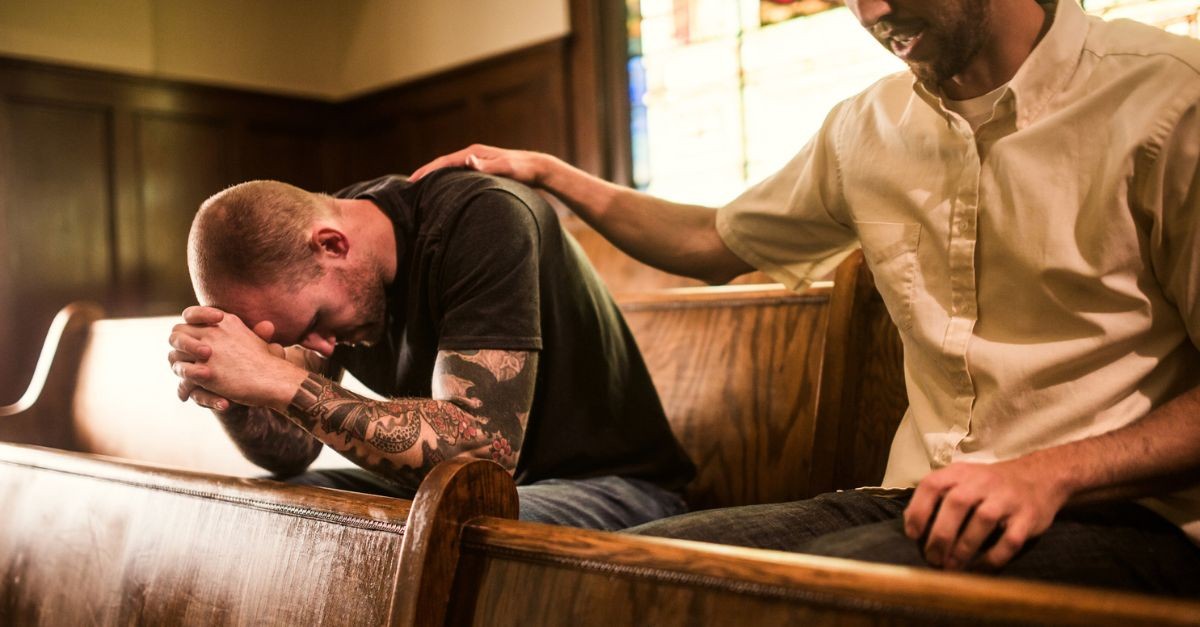 Men praying together; remembering God is in control; forgiveness